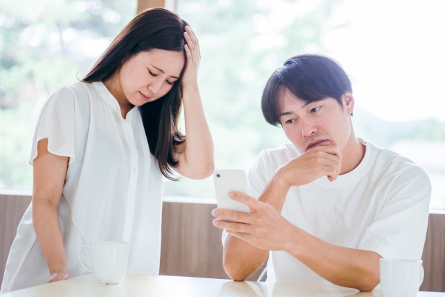 夫婦でスマホを見ている画像